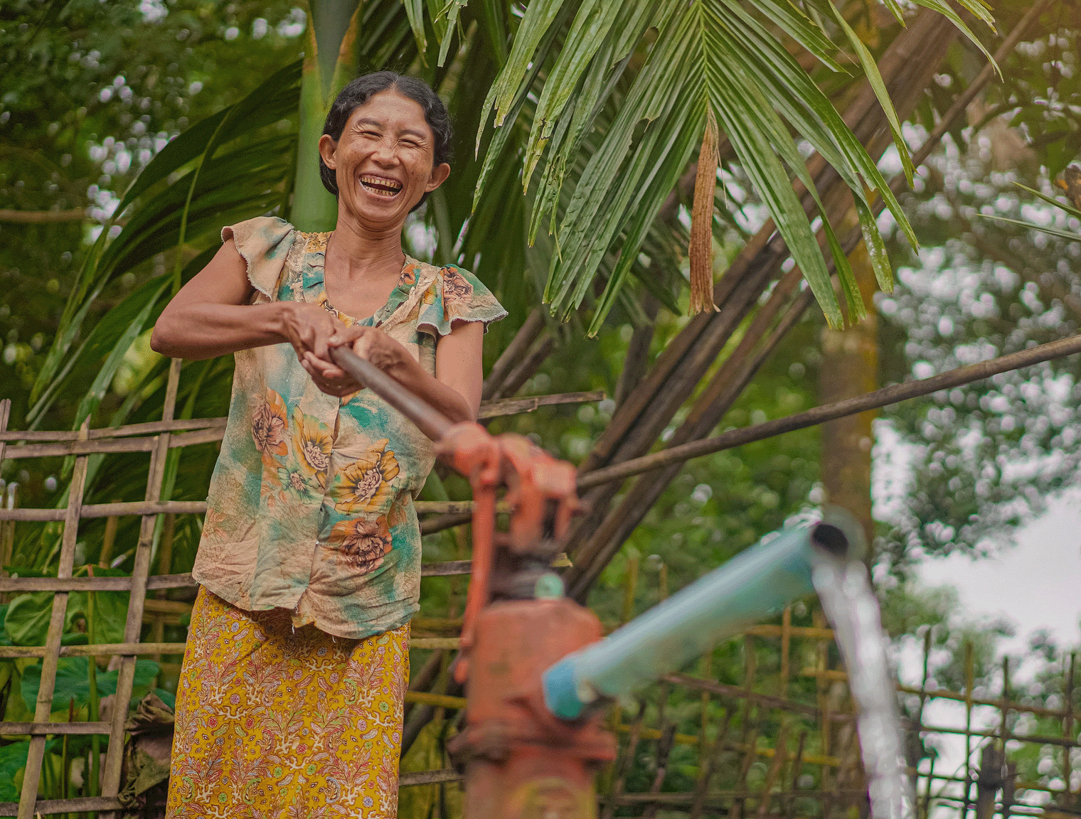 Woman at water pump in Myanmar