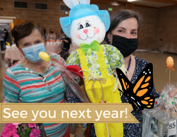 Two masked women hold up raffle prizes, including a bunny scarecrow. Text says "See you next year."