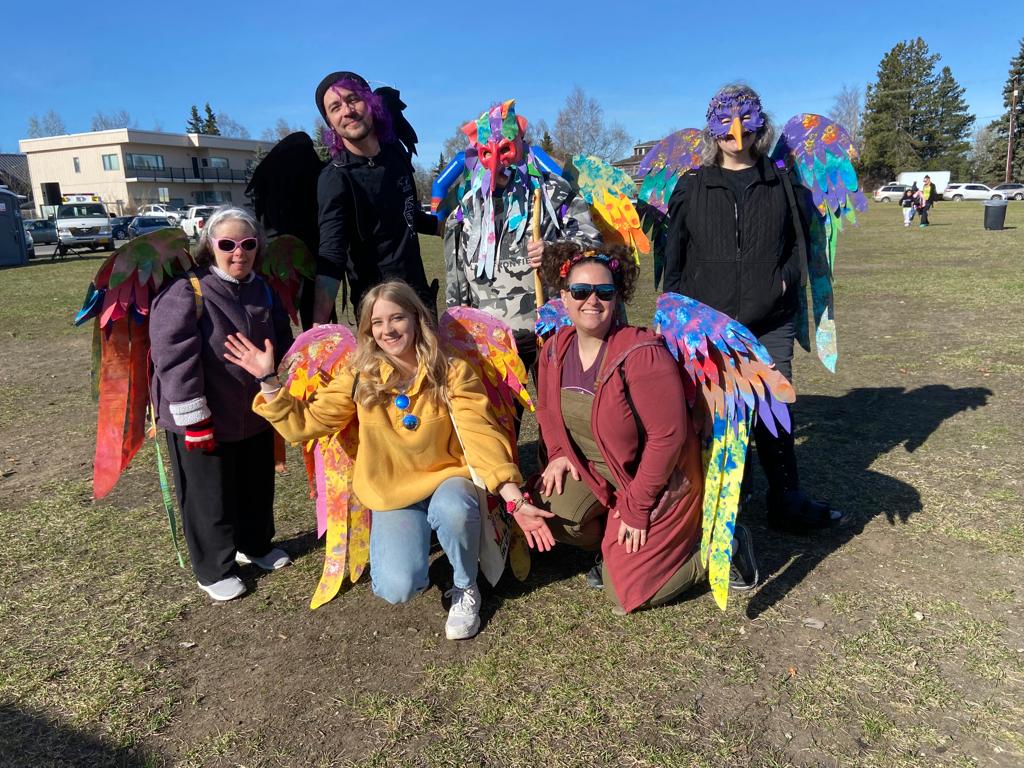 Six members of Hope Studios stand or kneel while wearing colorful handmade wings at Hope's annual 'Walk and Roll for Hope' event