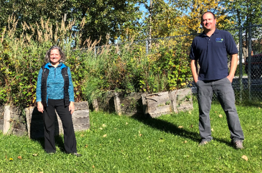 Sharon Miranda, Coordinator of Deaf Student Supports, and Michael Merritt, Deaf Navigator stand in front of a garden.