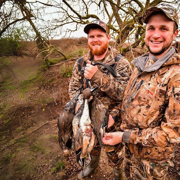 Two hunters pose after a hunt with California Waterfowl.