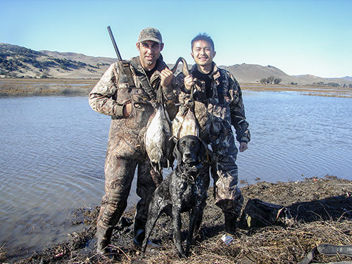 Two hunters pose after a hunt at Family Club with California Waterfowl.