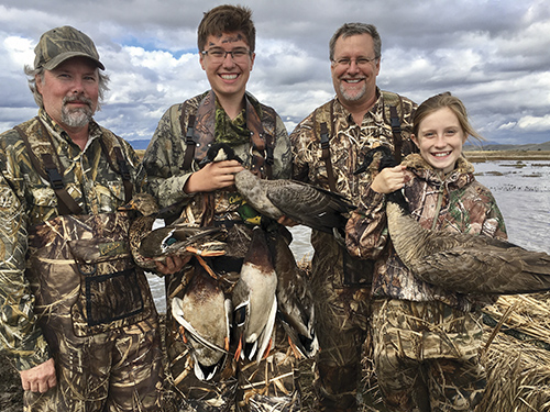 Two hunters pose after a hunt at Family Club with California Waterfowl.
