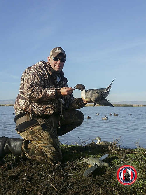 A veteran displays a pintal he shot at Gustine Gun Club during a hunt with California Waterfowl.