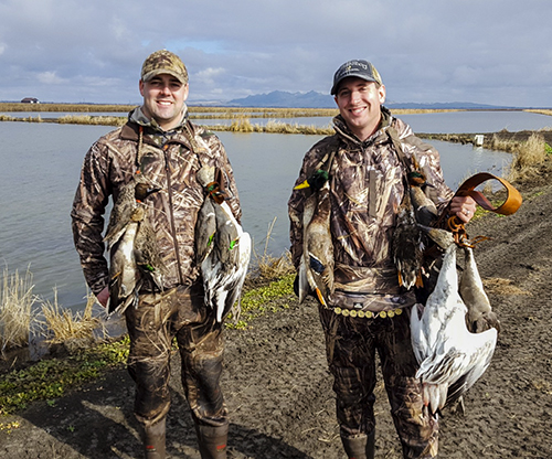 Two hunters smile after a hunt with California Waterfowl.