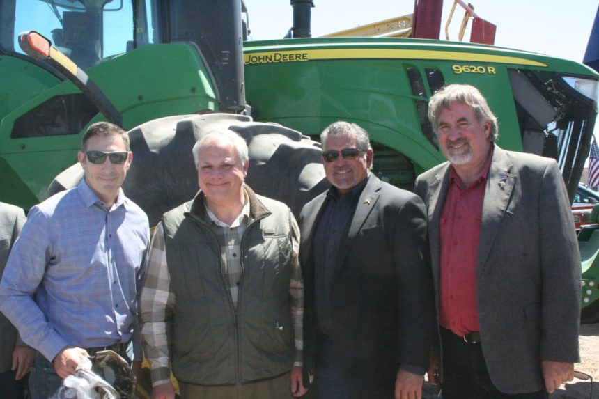 Photo of CWA VP for Legislative Affairs and Public Policy Mark Hennelly, U.S. Secretary of the Interior David Bernhardt, CWA Board Chair Rocque Merlo and U.S. Rep. Doug LaMalfa in front of a tractor.