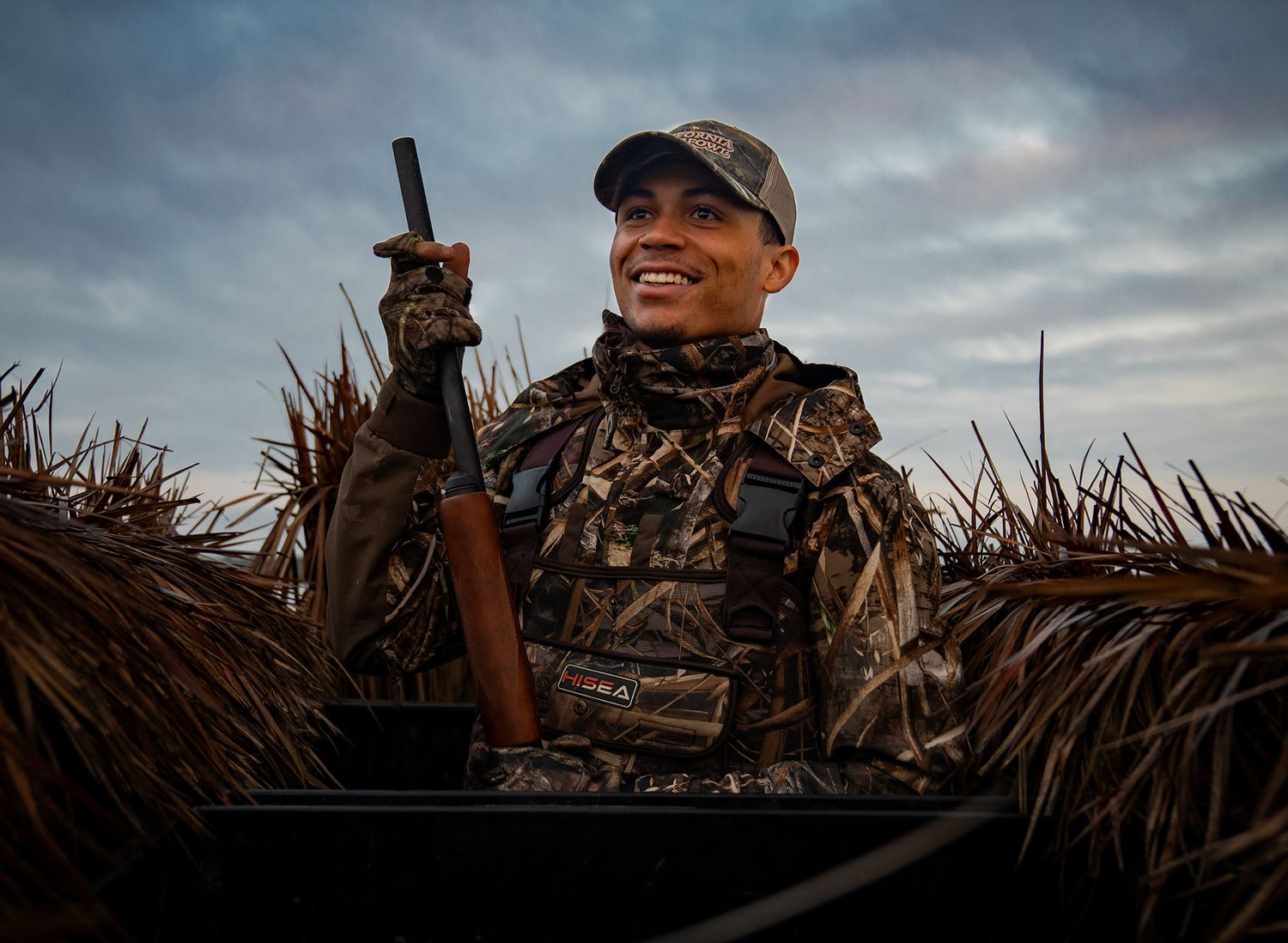 A guide unloads a strap of ducks at California Waterfowl's Duck Camp.