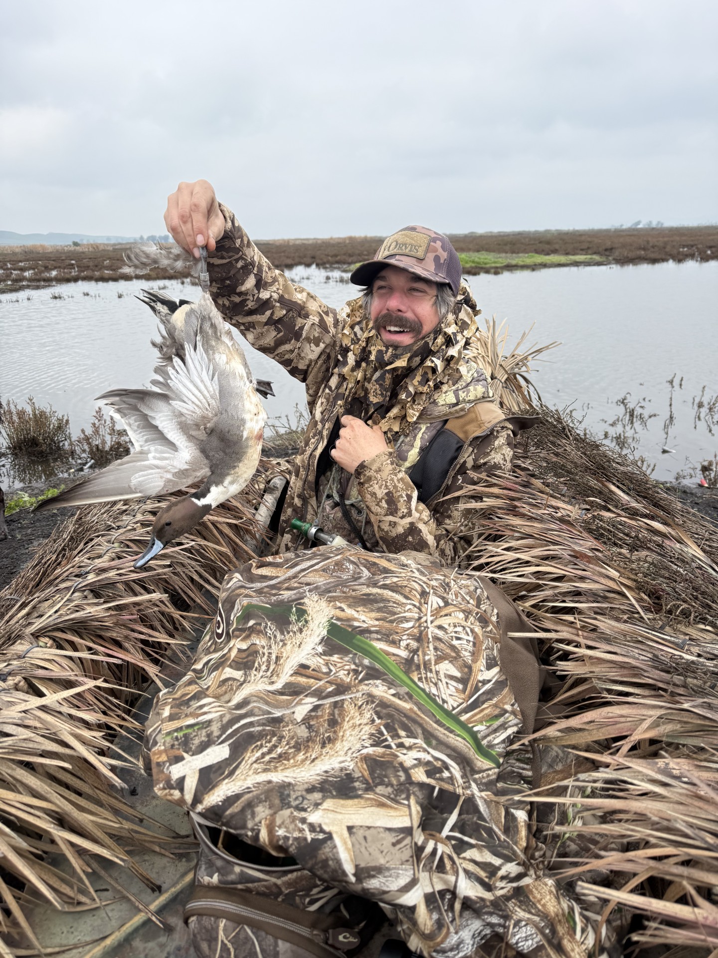 Image of a hunter walking through decoys before sunrise