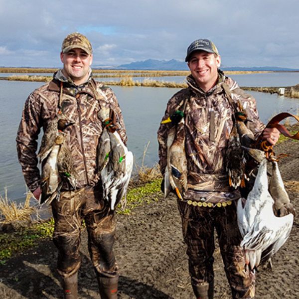 Two hunters smile after a hunt with California Waterfowl.