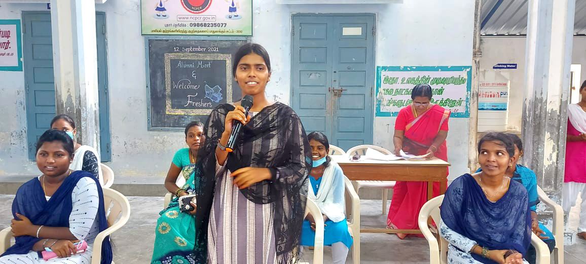 Young woman in India talking into a microphone