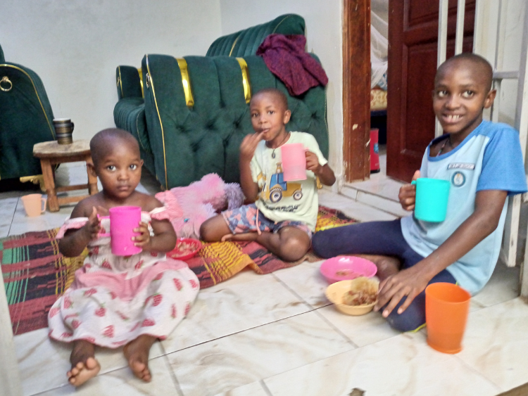 Divine having lunch with his younger siblings