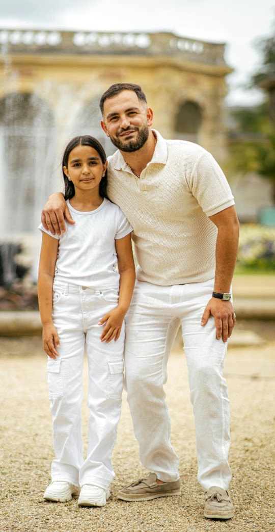 A person and child posing for a pictureDescription automatically generated