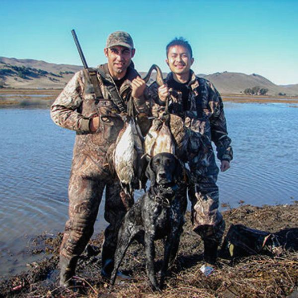 Two hunters pose after a hunt at Family Club with California Waterfowl.