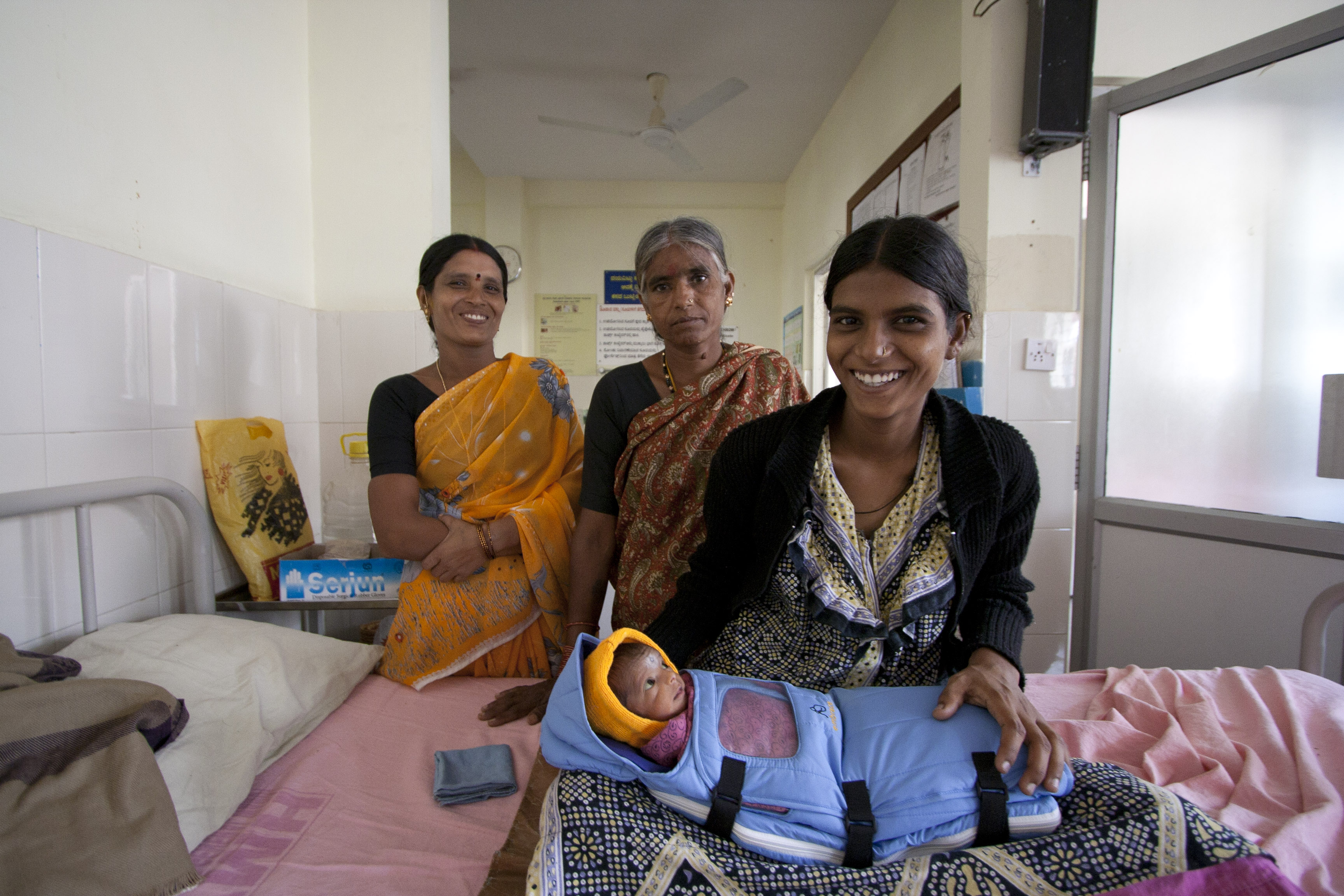 Newborn wrapped in an Embrace Portable Incubator