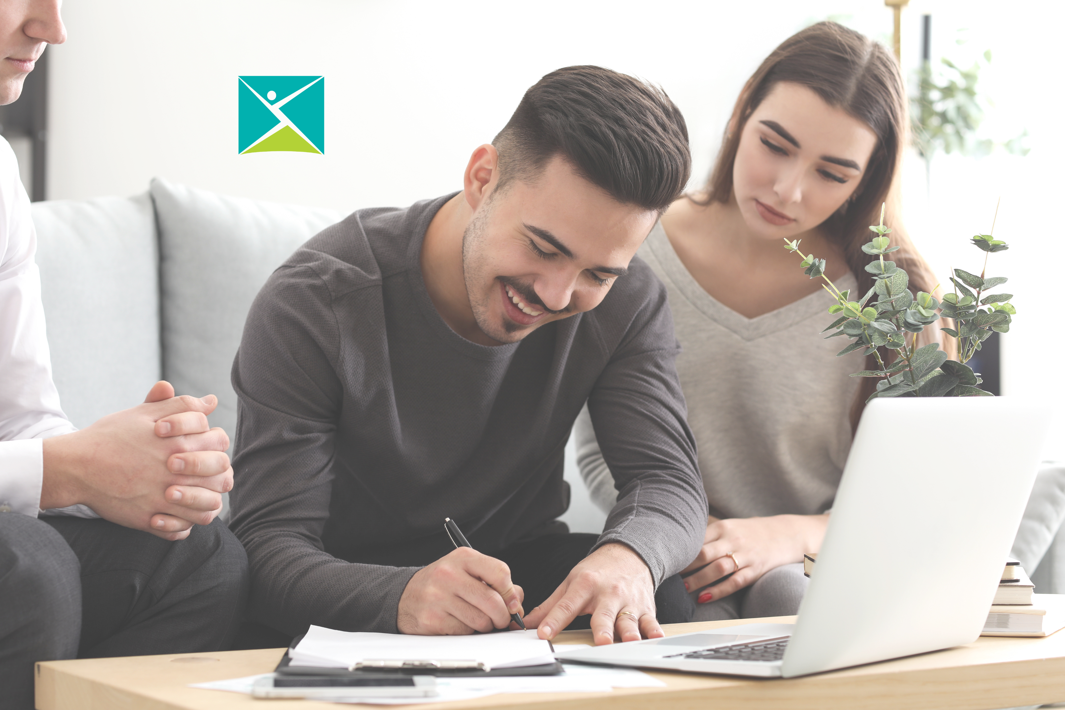 2 people writing on paper with a computer out